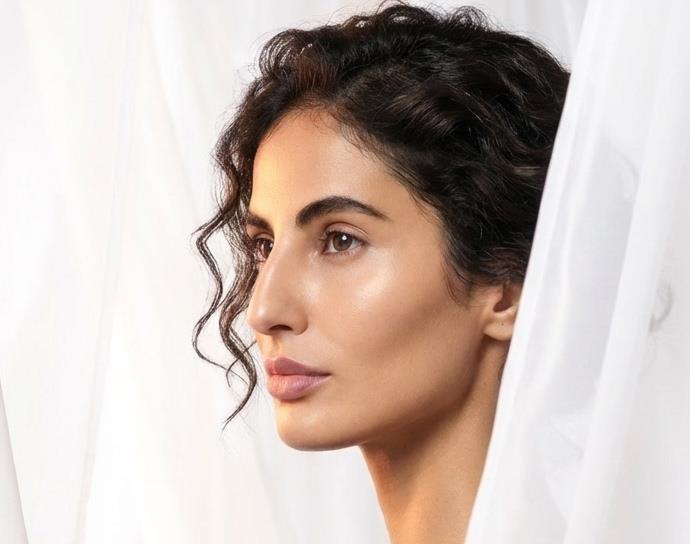 Model framed by curtains